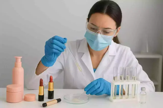 Scientist testing cosmetic products like lipsticks, foundation, and skincare items in a laboratory for safety and quality analysis
